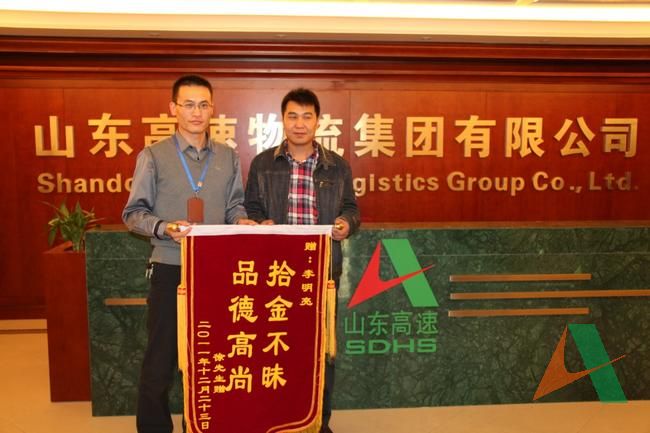 失主徐先生將錦旗送到李明亮的手中